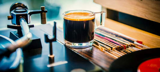 Coffee cup on a stack of vinyl records